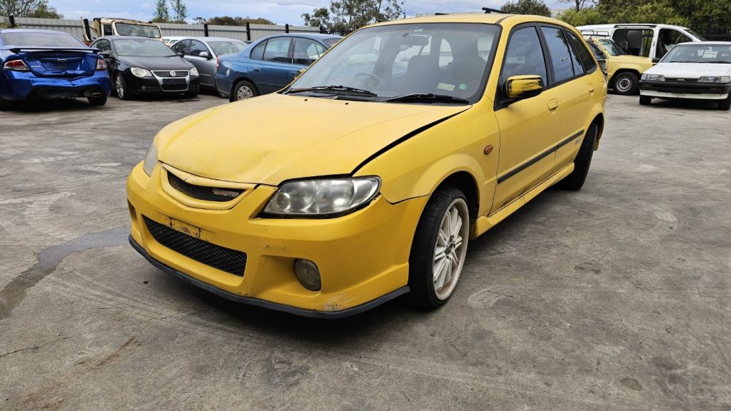 Car Wreckers - Mazda 323 2001 Yellow Auto Petrol