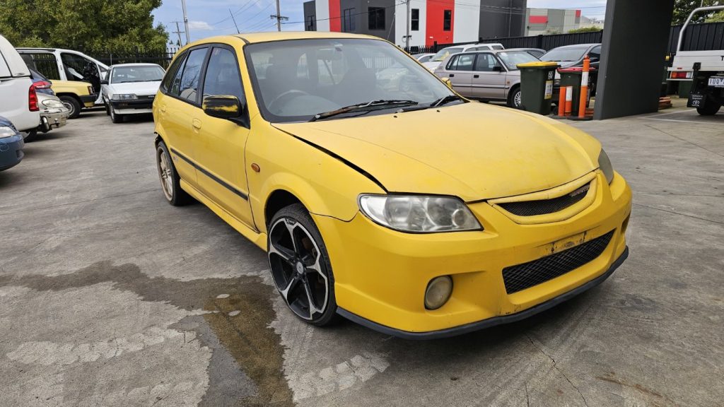 Car Wreckers - Mazda 323 2001 Yellow Auto Petrol
