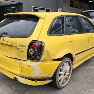 Car Wreckers - Mazda 323 2001 Yellow Auto Petrol