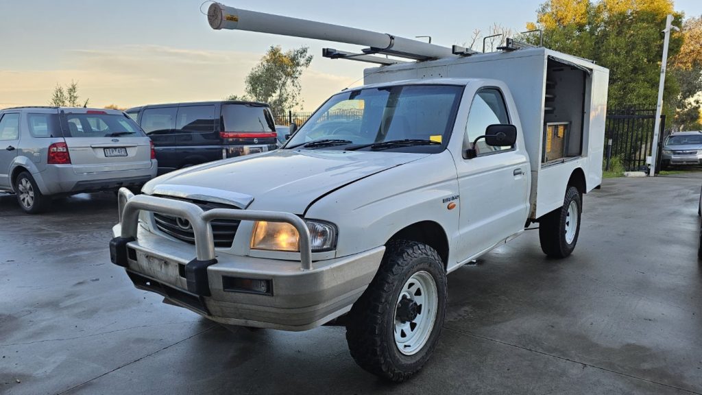 Car Wreckers - Mazda Bravo 2003 White Auto Petrol